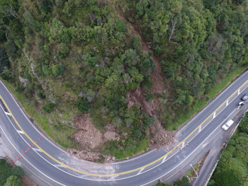 Photo from the drone taken on Saturday morning showing the extent of the first landslides. The landslide to the left came down early on Saturday, and had already been partially cleared by contractors. The one to the right came down while the contractors were working (Photo: GNS Science).