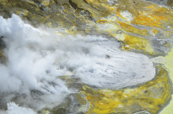 Figure 1: Aerial view of Whakaari/White Island, 20 March 2024 showing grey coloured pool in 2019 Crater (centre) with geysering. Photograph credit: Brad  Scott, GNS Science.