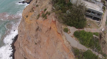 Drone photo of Whitewash Head showing new cracks in the cliff face - the rest of the road on the right fell into the sea during the 13 June 2011 earthquake