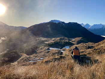 This is the view NE at the Solution Ranges site. This flat spur is a strong schist where researchers have a site. We intend to build where Tim is in the photo, which is just back from the edge.