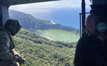 Tech Miles flying over of Blue Lake on Raoul Island, showing the landslides on the crater wall and the RNZN Canterbury at anchor in the background