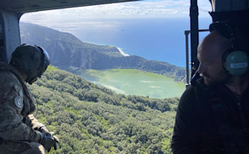 Tech Miles flying over of Blue Lake on Raoul Island, showing the landslides on the crater wall and the RNZN Canterbury at anchor in the background