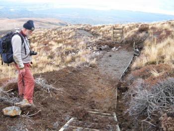 Brad Scott inspecting ballistic block damage to the Tongariro Alpine Crossing Track