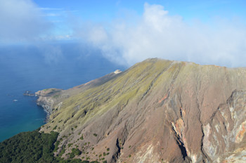 Aerial view of Whakaari/White Island, 24 May 2024, showing thin, green ash deposits.