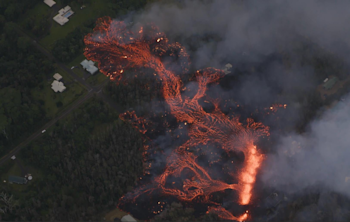 A lava flow released by one of the recent fissures in Leilani Estates in the Puna District of Hawaii threatens roads, houses, and infrastructure. (Photo by Ann Kalber of Tropical Visions Videos).