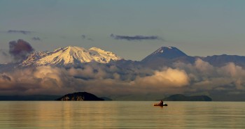 Serene Lake Taupō with Mt Ruapehu and Mt Ngauruhoe in the background.  