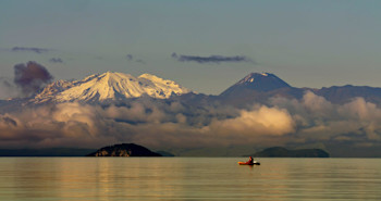 Serene Lake Taupō with Mt Ruapehu and Mt Ngauruhoe in the background.  