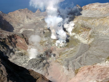 View of active vent area from the summit on 4 October 2013. View of active vent area from the summit on 4 October 2013. Note how the active vent area in the centre has moved to the left and the pinky-red landslide debris in the foreground.