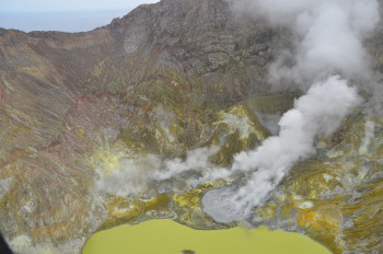 Aerial view of Whakaari/White Island, 7 February 2024 showing grey coloured pool in 2019 Crater (centre) now isolated from the lake and active steam and gas plumes from fumaroles. Photograph credit: Brad Scott, GNS Science. 