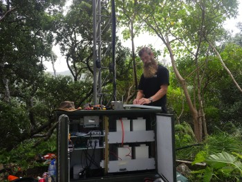 GeoNet technician Dave Whitelaw,  installing the BGAN antenna at Boat Cove with the new batteries shown in the cabinet.