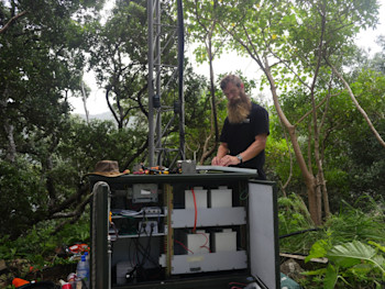 GeoNet technician Dave Whitelaw,  installing the BGAN antenna at Boat Cove with the new batteries shown in the cabinet.