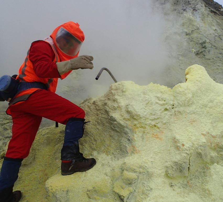 Scientist collecting gas samples from one of the high temperature fumaroles.