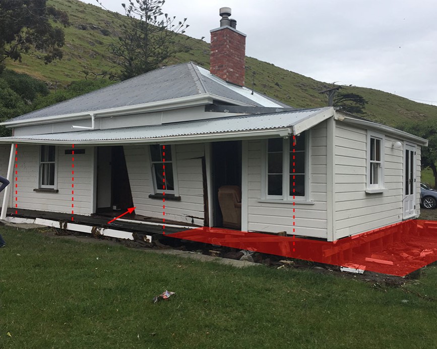 Tsunami damage to the cottage at Little Pigeon Bay. The red area and lines are where the veranda and poles were. Photo: Penny Aitken.